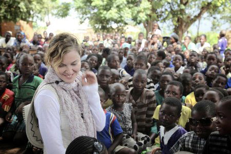 This image released by Liz Rosenberg Media shows singer Madonna visiting school children in Chorwe, Malawi on Wednesday, April 3, 2013. Madonnas foundation, Raising Malawi, has built ten schools in partnership with BuildOn which are currently educating over 4,000 students per year. (AP Photo/Liz Rosenberg Media)